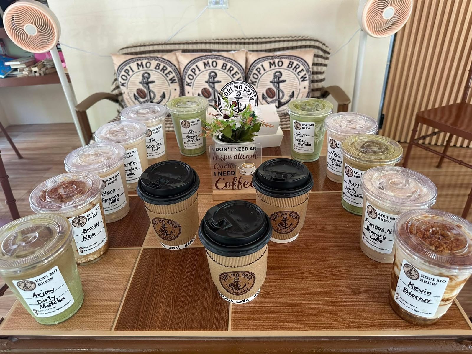 A group order of labelled cups laid out on a table