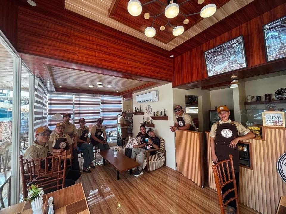 The Kopi Mo Brew crew in brown aprons inside the shop